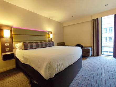 Premier Inn Airport Hotel bedroom showing kingsize bed and sofa-bed
