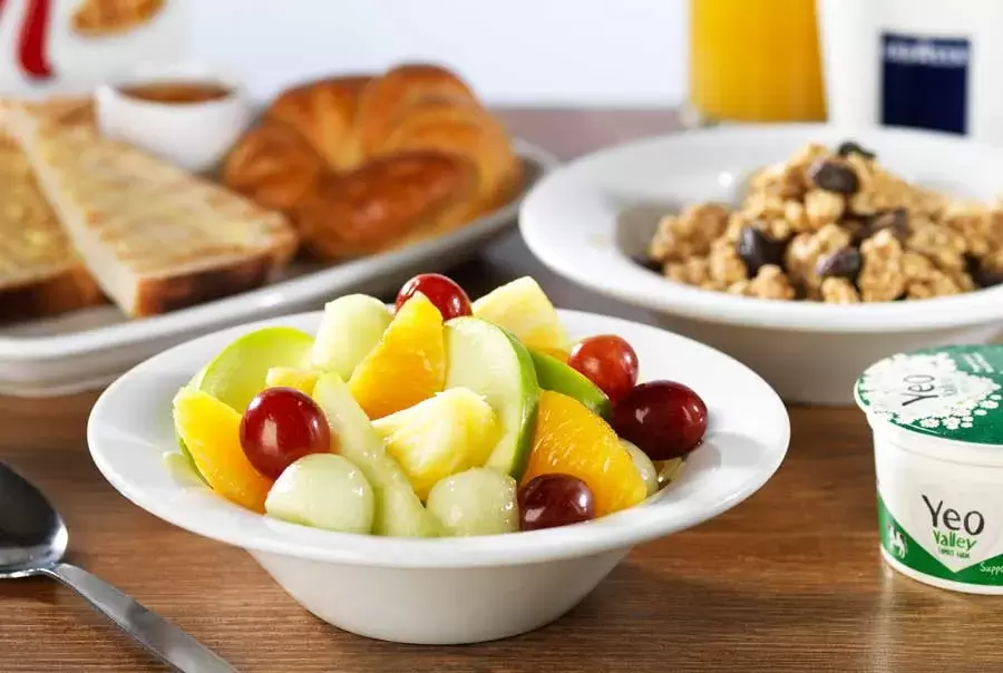 Travelodge-breakfast-showing-fresh-fruit-salad-bowl-yogurts-museli-pastries