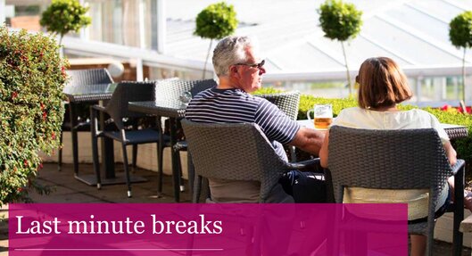Warner-Hotels-couple-enjoying-drink-outside-on-last-minute-break